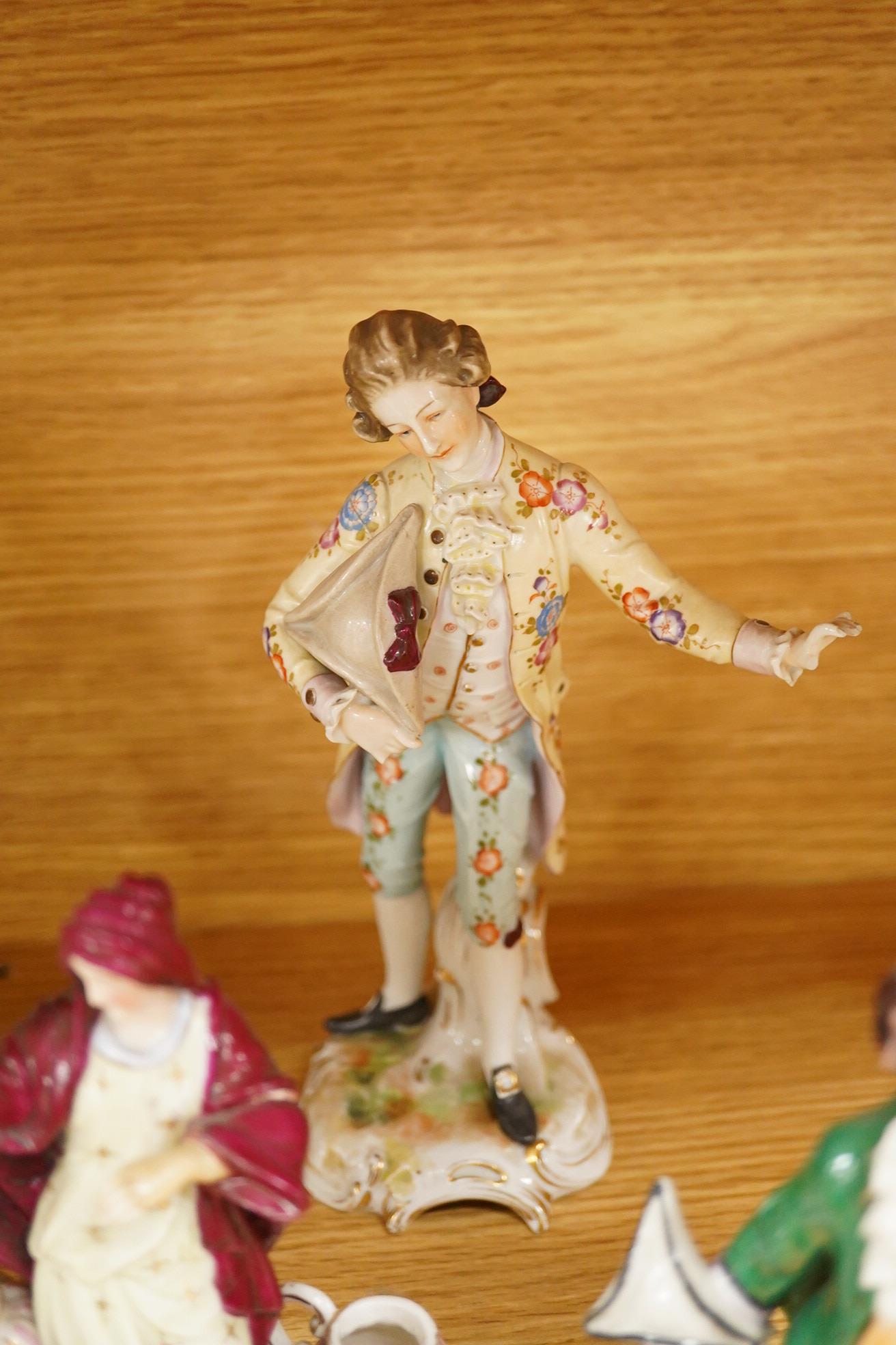 Nine continental figurines, to include Dresden porcelain lace examples, together with a resin figurine of Queen Elizabeth, largest 23cm high